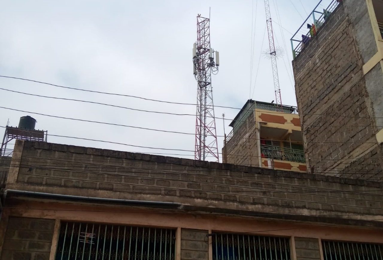 Electric cables, telecomm mast and buildings